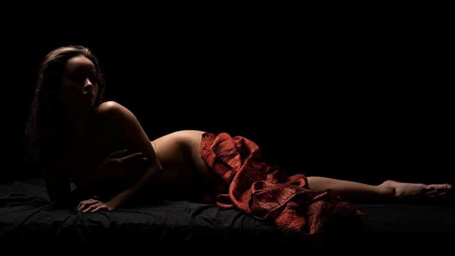 woman lying down and posing naked
