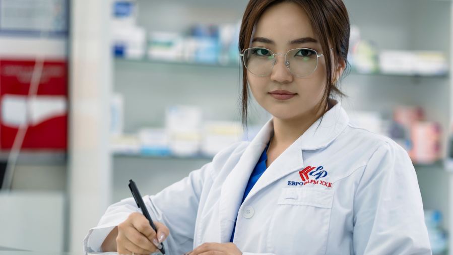Woman in lab coat writing notes