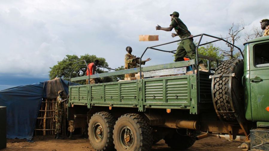Soldiers unloading supplies from truck