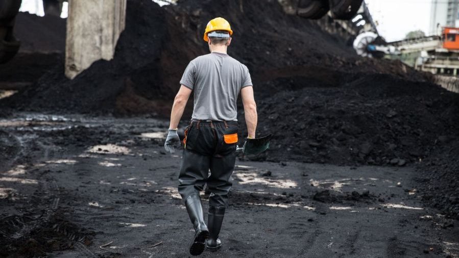 Coal worker walking away on job site