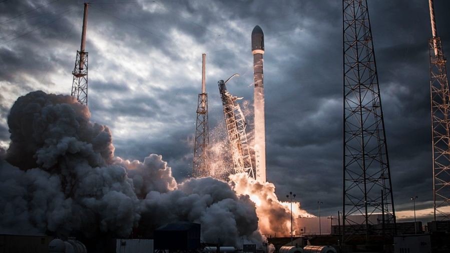 Smoke billows as a rocket launches into a dramatic evening sky, showcasing technological innovation.