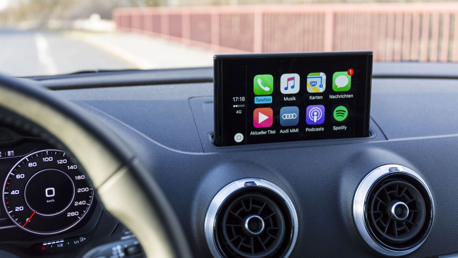 Photo of a luxury car's interior showcasing the digital navigation and audio display system.