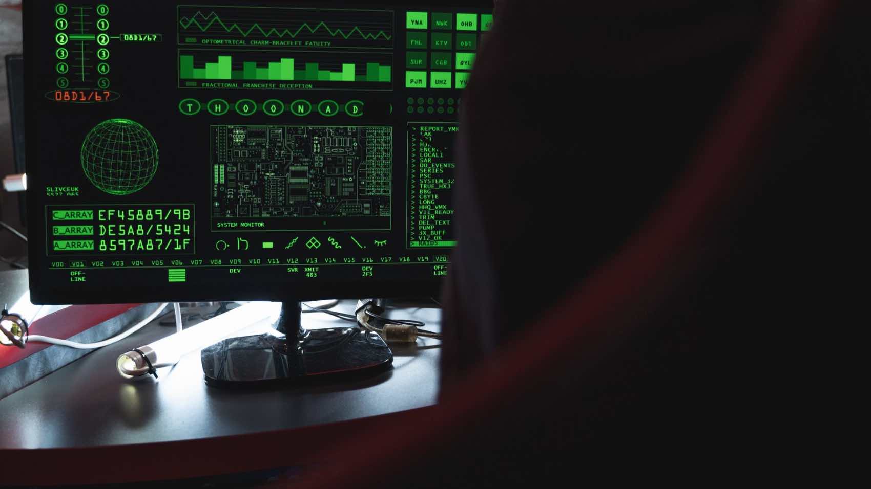 View of a computer monitor displaying green digital security code in an indoor setting.