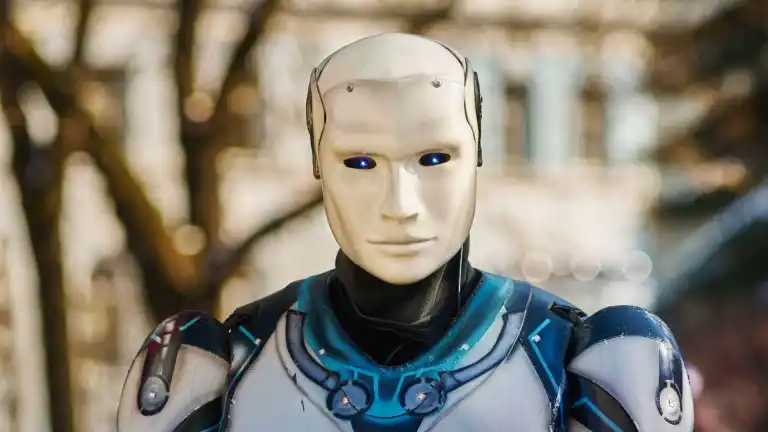 Close-up of a humanoid robot with a futuristic design posing outdoors.