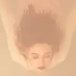 Artistic photo of a woman floating underwater in soft hues.
