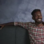 A happy man sitting on a couch