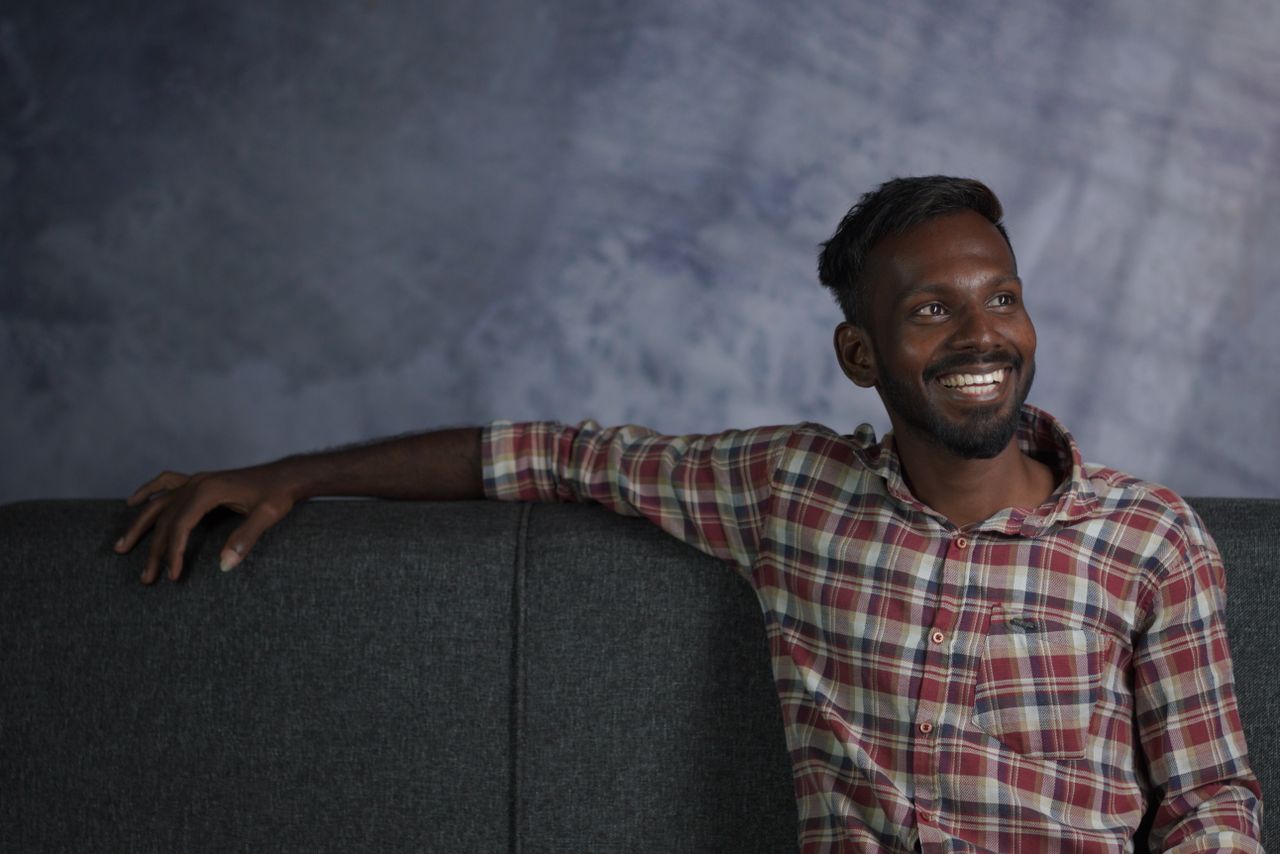 A happy man sitting on a couch